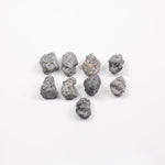 Close-up view of a sparkling gray diamond in a white gold setting.