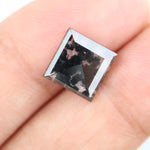 Premium lab-grown diamond with radiant square cut and distinctive black inclusions, offering a unique and sustainable choice for fine jewelry.