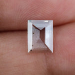 Emerald cut lab grown diamond loose stone with high clarity and subtle natural inclusions, transparent and ethically created for engagement ring or fine jewelry use