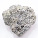 A close-up view of a grey diamond showcasing its unique salt-and-pepper appearance with visible mineral inclusions.