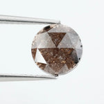 Close-up of a premium round cut brown lab-grown diamond with sparkling facets, showcasing eco-friendly, conflict-free quality and unique natural-like inclusions.