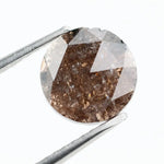 Close-up of a premium round cut brown lab-grown diamond with sparkling facets, showcasing eco-friendly, conflict-free quality and unique natural-like inclusions.