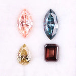 Set of four fancy color lab grown diamonds including emerald cut brown, pear shape yellow, marquise blue and pink loose diamonds for custom fine jewelry