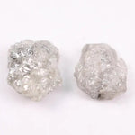 Natural rough gray diamond pair featuring raw, uncut beauty.