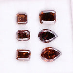 Set of premium brown lab-grown diamonds in emerald, pear, and octagon cuts displaying rich fancy color and brilliant faceting for custom fine jewelry designs.