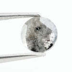 Round brilliant cut lab-grown salt and pepper diamond with unique gray and black inclusions, perfect for custom rings and fine jewelry.