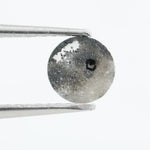 Round brilliant cut lab-grown salt and pepper diamond with unique gray and black inclusions, perfect for custom rings and fine jewelry.
