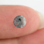 Round brilliant cut lab-grown salt and pepper diamond with unique gray and black inclusions, perfect for custom rings and fine jewelry.