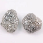 Raw gray diamond pair showing salt and pepper inclusions
