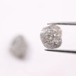 Raw gray diamond pair showing salt and pepper inclusions