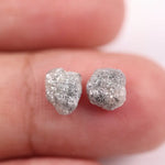 Raw gray diamond pair showing salt and pepper inclusions