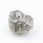 Large raw gemstones and rough diamond crystals displayed together.