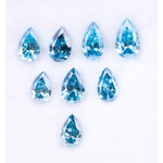 Eight vivid blue pear cut lab grown diamonds displayed on white background, featuring brilliant faceting, teardrop shape, and rich ocean blue tones ideal for custom engagement rings and fine jewelry.