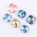 Six cushion cut lab grown diamonds in fancy colors including deep teal, vivid blue, pink, yellow, and light blue displayed on white background for fine jewelry design.
