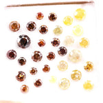 Assorted round brilliant cut natural diamonds in yellow and brown colors, loose fancy diamonds ideal for engagement rings, custom jewelry making, and diamond supply collection.