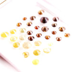 Assorted round brilliant cut natural diamonds in yellow and brown colors, loose fancy diamonds ideal for engagement rings, custom jewelry making, and diamond supply collection.