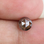0.78 carat brownish black natural diamond round cut loose stone with subtle dual tone color blend