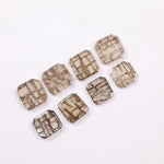 Square cut lab grown diamond with champagne tone and distinctive geometric grid-like inclusions, octagonal step cut, transparent stone for modern sustainable fine jewelry design.