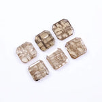 Six octagon step cut lab grown diamonds in champagne tones with visible natural-style inclusions, arranged on a white background for fine jewelry design.