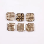 Six octagon step cut lab grown diamonds in champagne tones with visible natural-style inclusions, arranged on a white background for fine jewelry design.