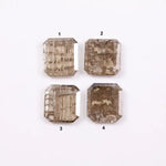 Four emerald-cut champagne lab grown diamonds with visible salt and pepper style inclusions, faceted step-cut stones in warm brown tones on white background