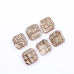 Six emerald cut octagonal lab grown diamonds featuring distinctive golden vein-like inclusions in a transparent champagne-toned base, displayed on a white background.
