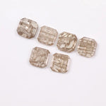 Six octagon step cut lab grown diamonds in fancy light champagne color with natural style inclusions, arranged on white background, ethically created loose stones for custom fine jewelry designs.