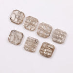 Emerald cut lab grown diamond with visible natural-style inclusions and salt and pepper pattern, octagon step cut sustainable gemstone for engagement ring or custom fine jewelry.