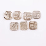Emerald cut lab grown diamond with visible natural-style inclusions and salt and pepper pattern, octagon step cut sustainable gemstone for engagement ring or custom fine jewelry.