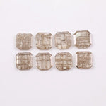 Eight square step cut lab grown diamonds in champagne tone arranged in two rows, featuring visible natural-style inclusions and emerald-style faceting on a white background.