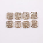Eight square step cut lab grown diamonds in champagne tone arranged in two rows, featuring visible natural-style inclusions and emerald-style faceting on a white background.