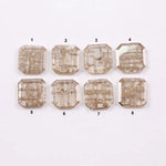 Eight square step cut lab grown diamonds in champagne tone arranged in two rows, featuring visible natural-style inclusions and emerald-style faceting on a white background.