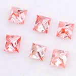 Six square princess cut pink lab grown diamonds in varying shades from light blush to vivid pink, displayed on a white background, featuring brilliant faceting and high clarity for luxury jewelry settings.
