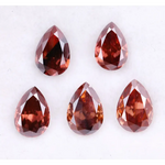 Five pear-shaped lab grown diamonds in fancy deep pinkish red color arranged on a white background, featuring brilliant faceting and teardrop cut for engagement rings and custom fine jewelry.