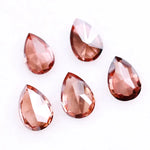 Five pear-shaped lab grown diamonds in fancy deep pinkish red color arranged on a white background, featuring brilliant faceting and teardrop cut for engagement rings and custom fine jewelry.