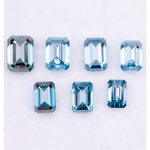 Close-up of emerald-cut lab-grown blue diamonds showcasing exceptional clarity and vibrant color, ideal for high-end jewelry designs.