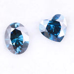 Oval and heart shaped fancy deep blue lab grown diamonds with brilliant faceting, showcasing vivid teal blue tones and VS clarity on a white background.