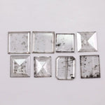 Square step-cut lab grown diamond with beveled edges and geometric faceting, loose ethical man made diamond for engagement ring or custom fine jewelry setting displayed on white background.