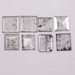 Square step-cut lab grown diamond with beveled edges and geometric faceting, loose ethical man made diamond for engagement ring or custom fine jewelry setting displayed on white background.