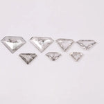 Seven clear lab grown diamonds in geometric faceted cuts arranged on white background, showing natural-style inclusions and transparent brilliance for jewelry making.