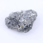 Close-up of rough diamond stone highlighting its natural shape and pristine unpolished surface for jewelry.