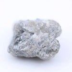 Raw diamond with rugged edges and natural brilliance, perfect for unique handcrafted jewelry designs.