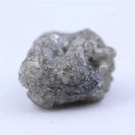Close-up of uncut diamond showcasing natural imperfections, textures, and authentic gemstone beauty.