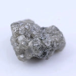 Close-up of uncut diamond showcasing natural imperfections, textures, and authentic gemstone beauty.