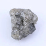 Close-up of uncut diamond showcasing natural imperfections, textures, and authentic gemstone beauty.