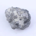 Raw natural diamond crystal before cutting with irregular shape and natural sparkle under light