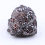 Uncut red tone rough diamond crystal with natural color variation and raw gemstone texture