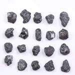 Black diamond with deep dark color displayed in a polished luxury jewelry setting