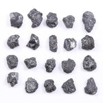 Black diamond with deep dark color displayed in a polished luxury jewelry setting