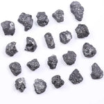 Black diamond with deep dark color displayed in a polished luxury jewelry setting